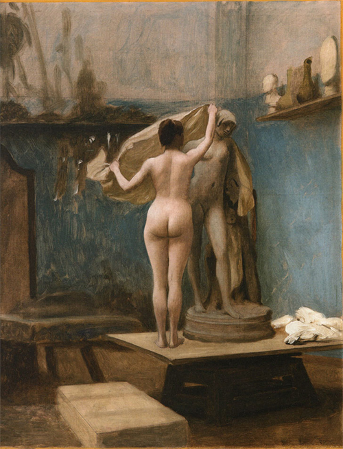 A nude woman stands with her back to the viewer, unveiling a draped classical statue in a dimly lit artist's studio